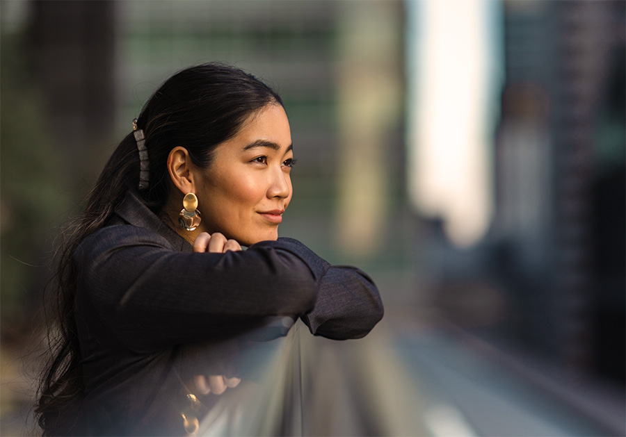 women sitting alone on steps city background